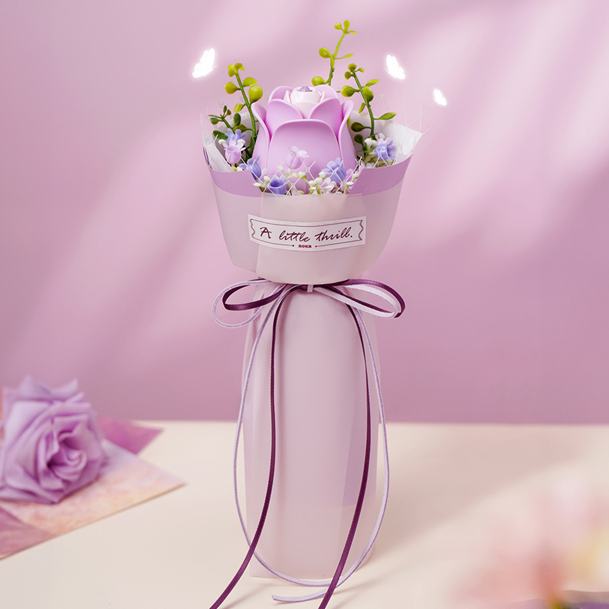 ROKR Purple Rose AF021 finished bouquet in pink vase against pink backdrop