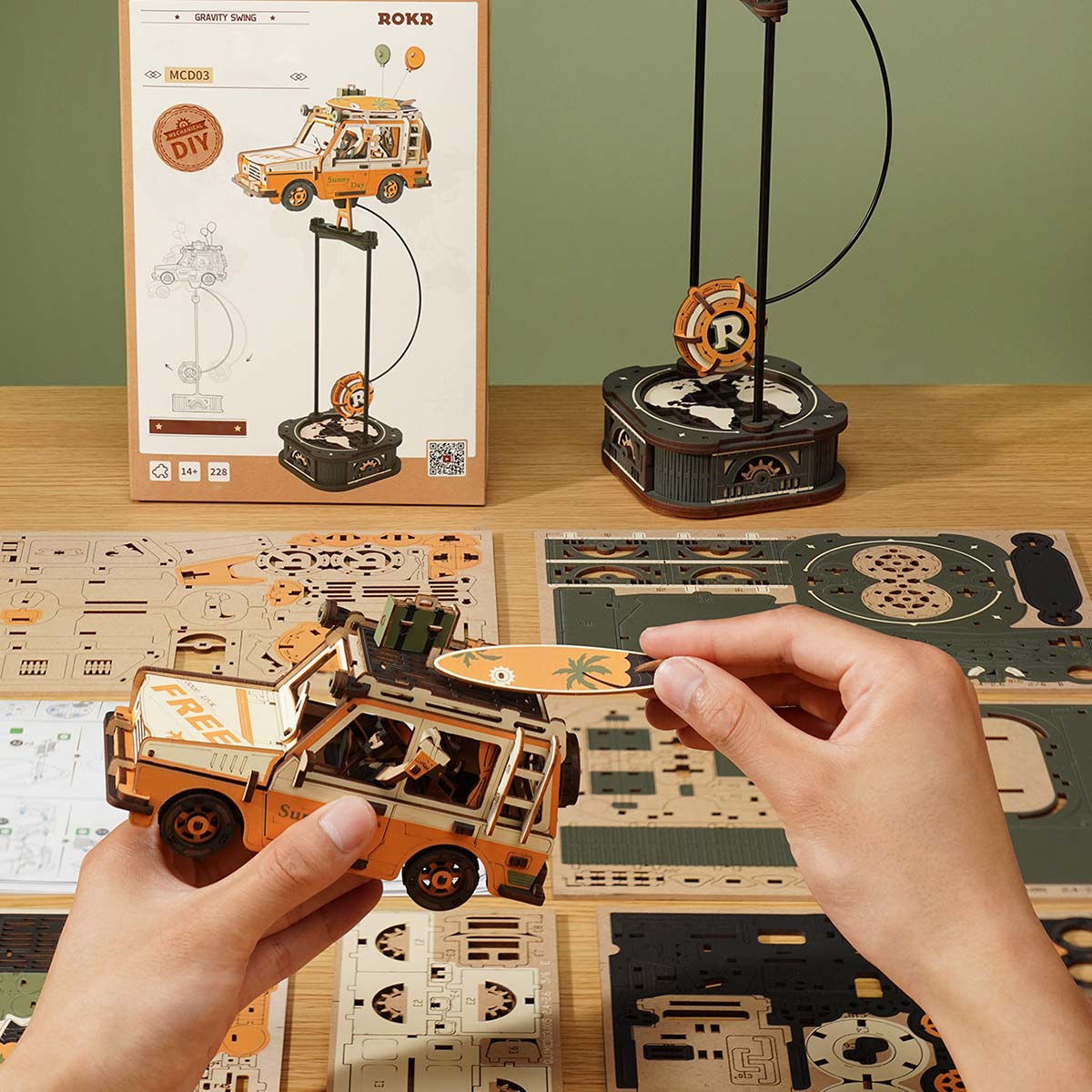 ROKR Road Tripper MCD03 assembly scene with product box and wooden parts sheet