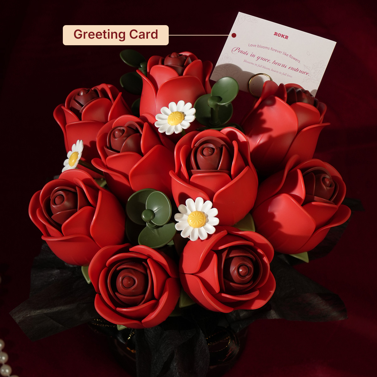 Red Rose Bouquet with greeting card in dramatic dark red scene