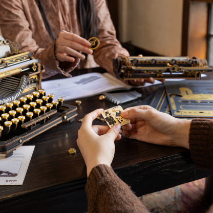 ROKR Mechanical Typewriter LK703B assembly scene with hands and parts