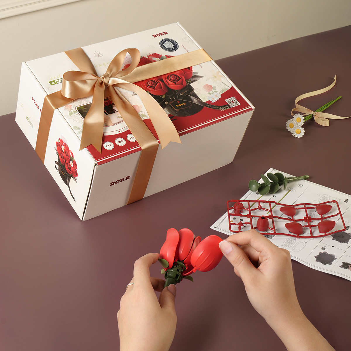 Red Rose Bouquet assembly scene with gift box, manual, and flower parts
