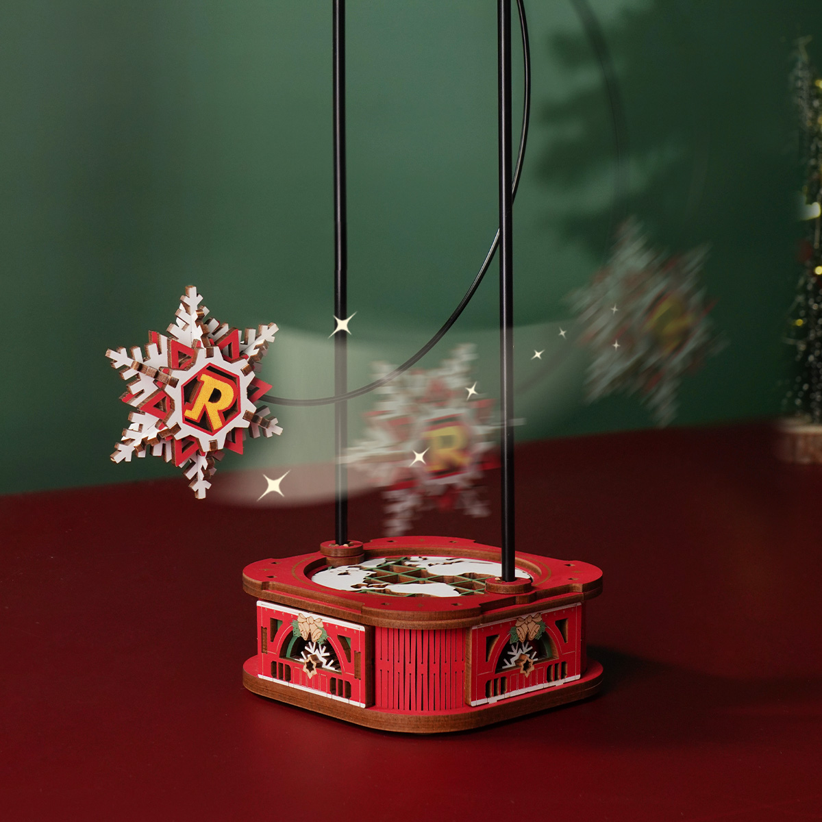Santa on Skis snowflake pendulum swinging above red base