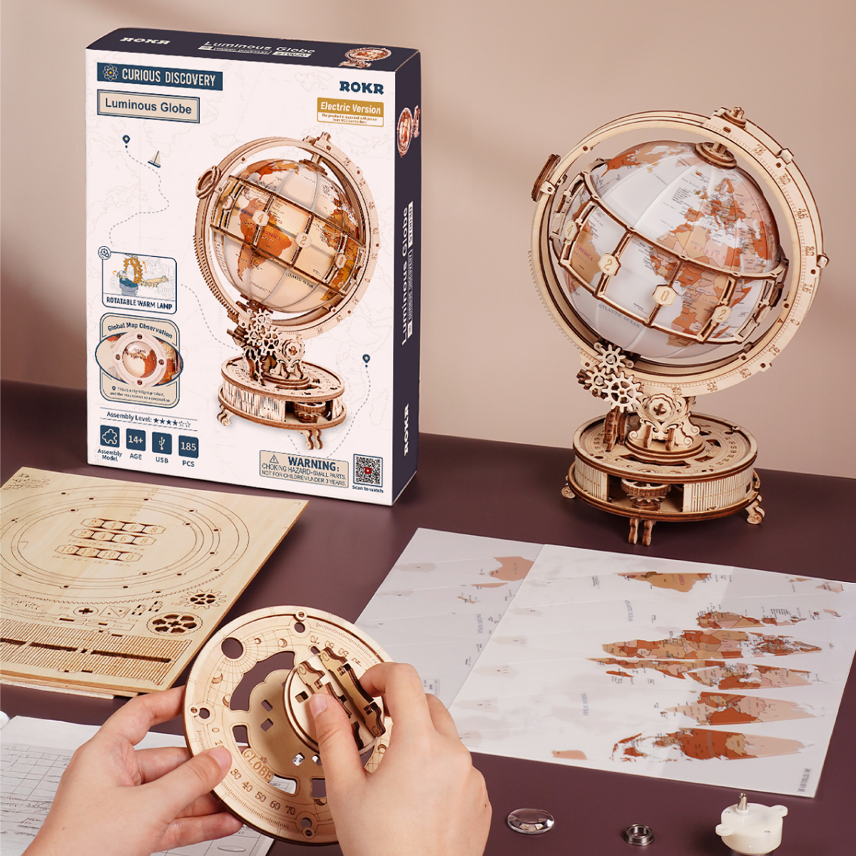 Luminous Globe assembly scene with package, tools, map sheet, and model