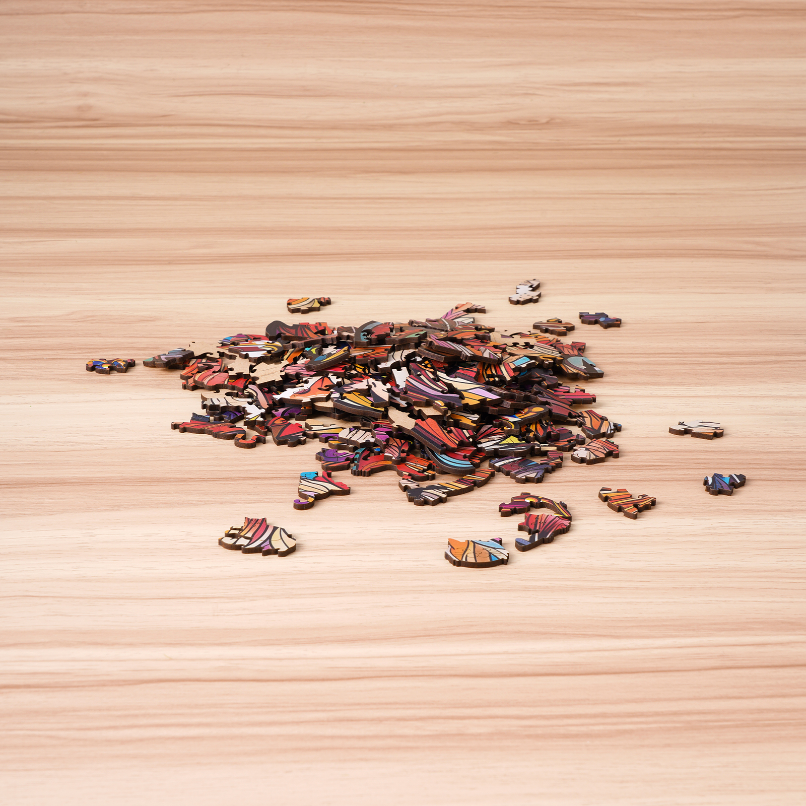 Rowood Cat King scattered colorful wooden puzzle pieces on tabletop