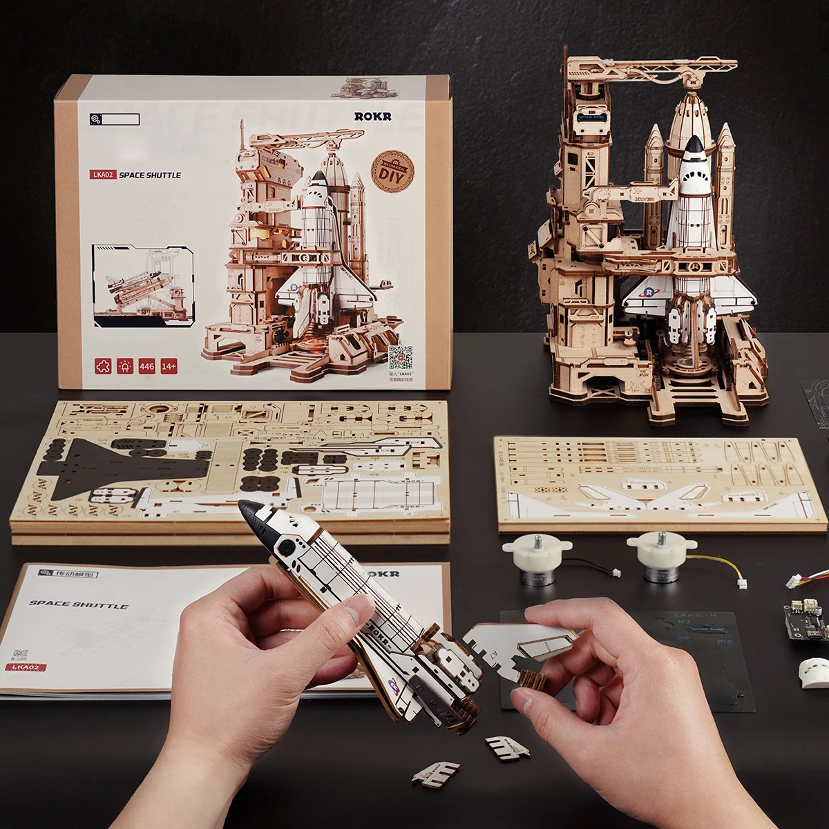 Space Shuttle assembly scene with package, instructions, and wooden parts