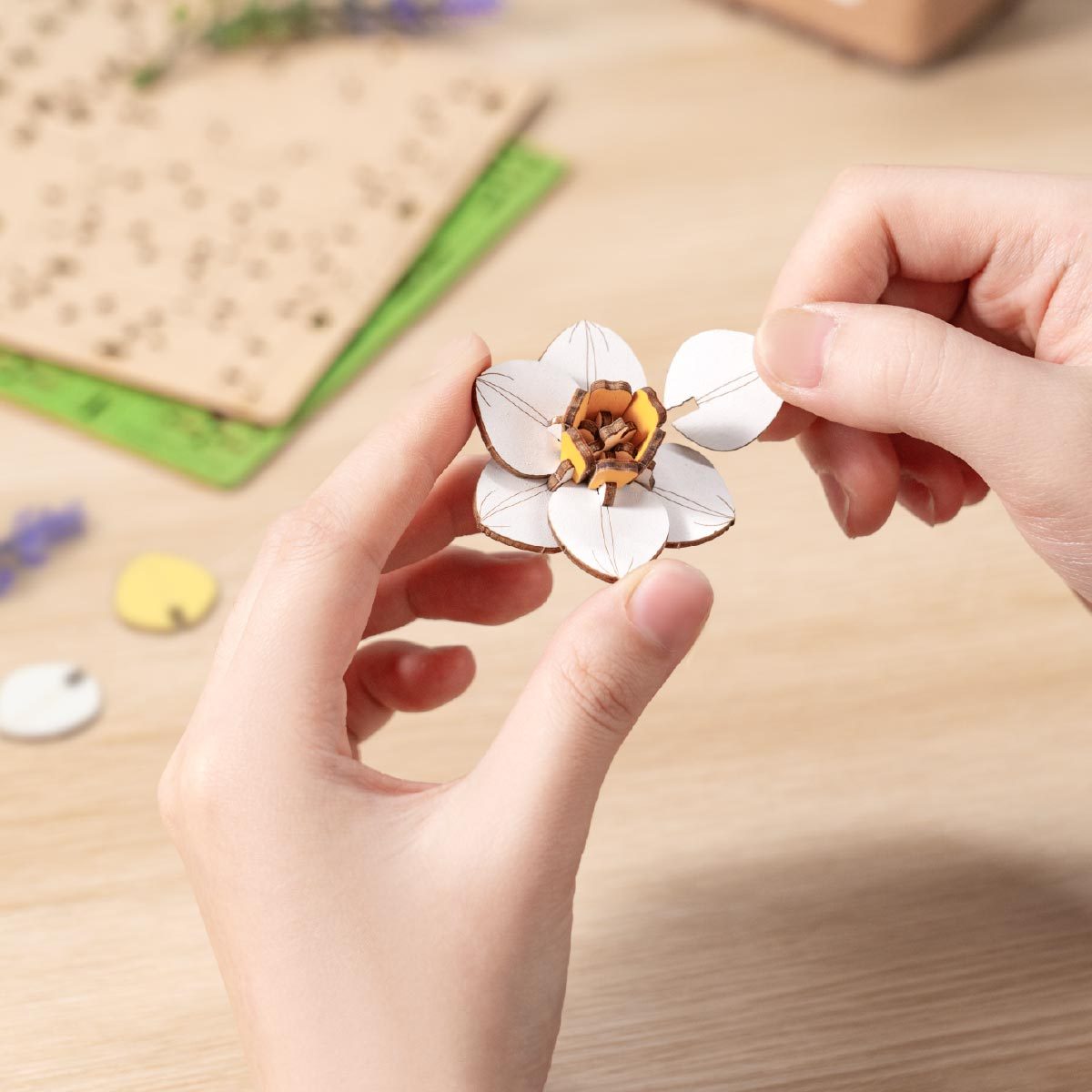 Narcissus wooden flower petal assembly close-up on craft table